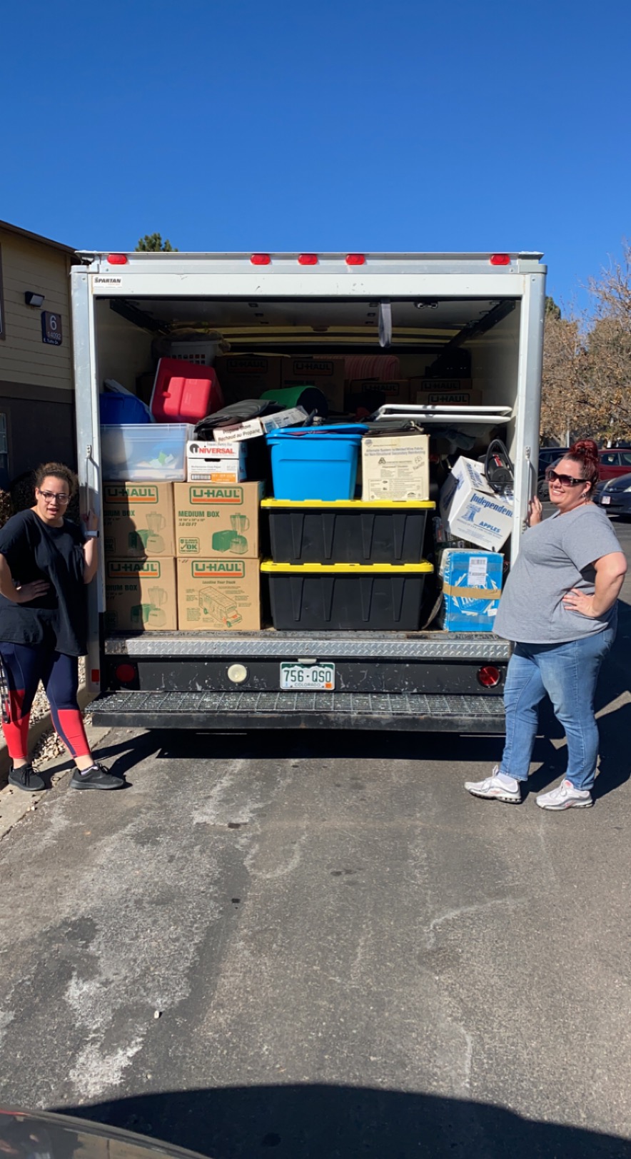 Two team members with a fully packed truck