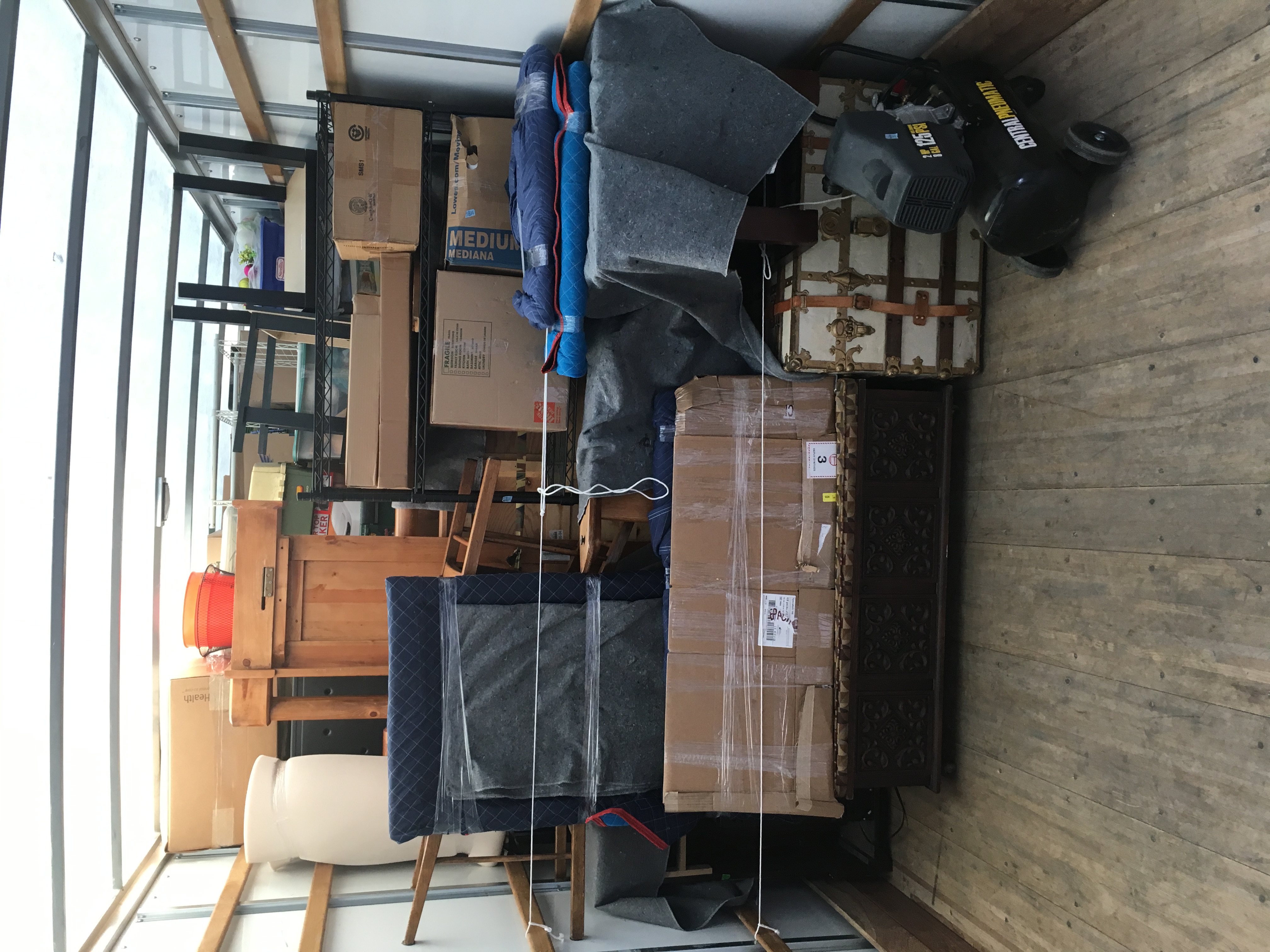 A loaded moving truck full of furniture and boxes